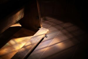 a wooden bench sitting on top of a tiled floor